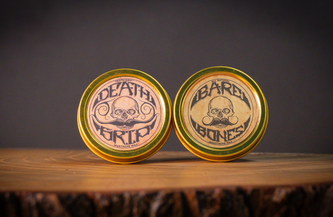 Death Grip extra strong hold mustache wax and Bare Bones medium hold wax tins displayed