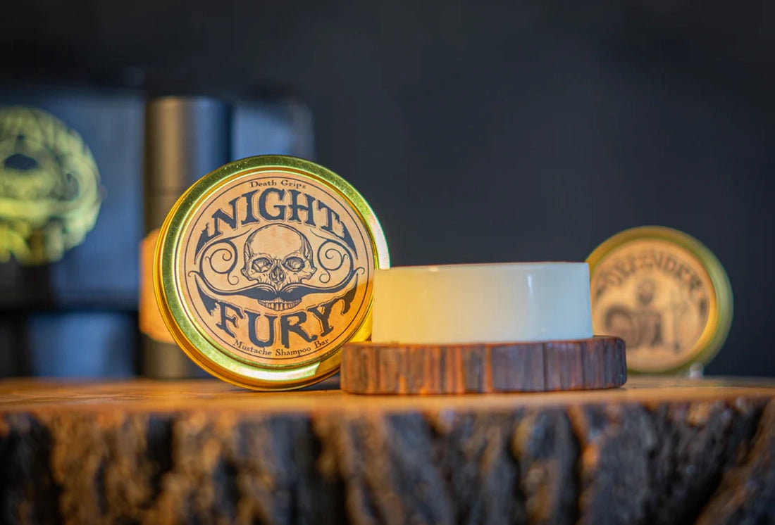 Death Grip Night Fury beard and mustache wash bar open tin citrus shampoo bar on wooden surface