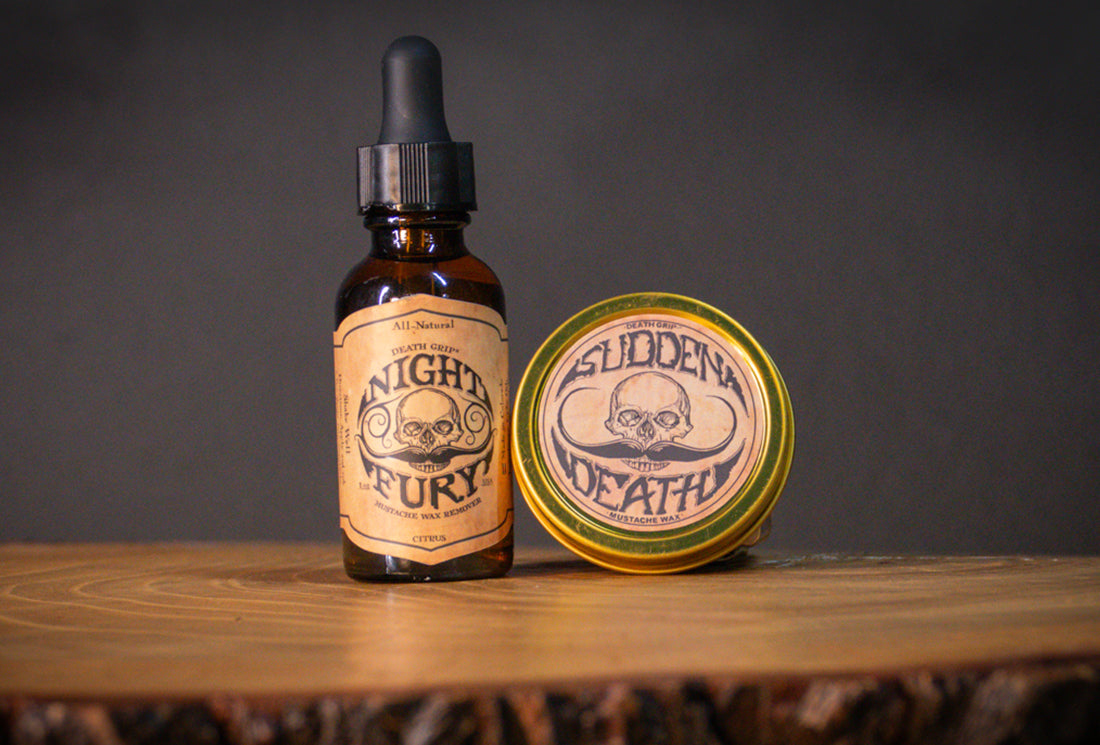 Sudden Death Strong Hold Mustache Wax and Night Fury Remover Oil set with tins displayed on wooden surface