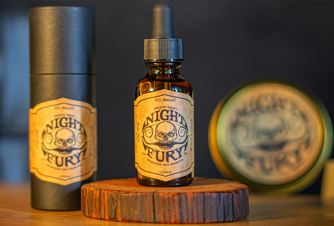 Death Grip Night Fury Mustache Wax Remover oil bottle with packaging on wooden surface