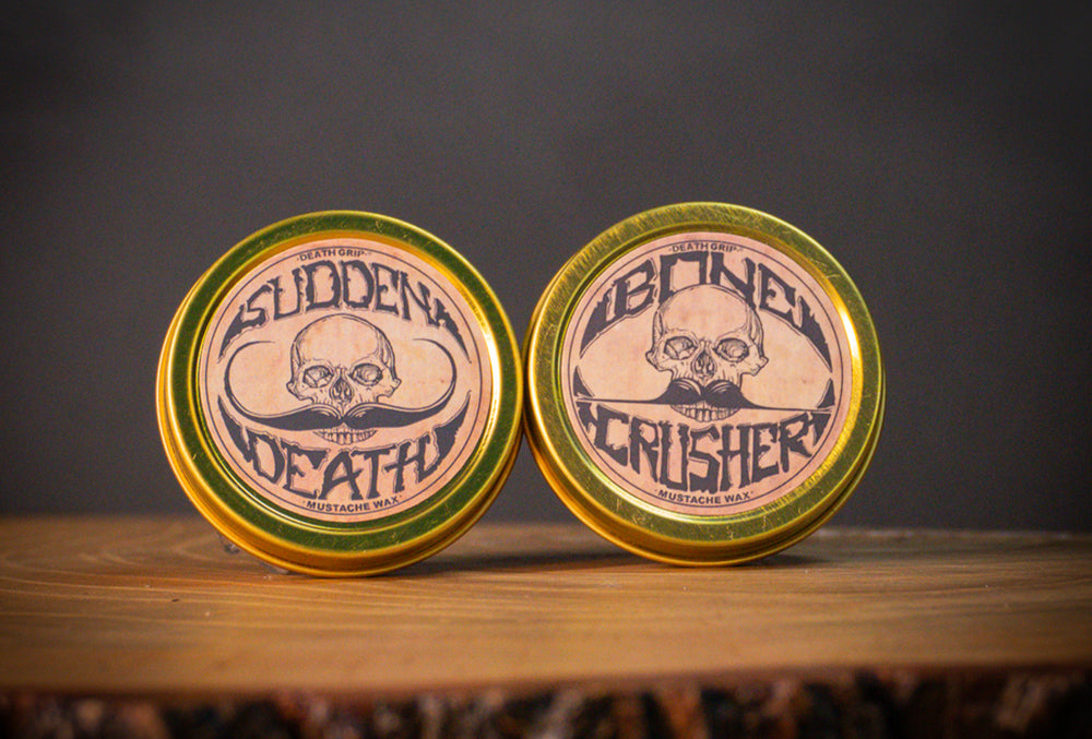 Sudden Death strong hold and Bone Crusher mustache wax tins side by side