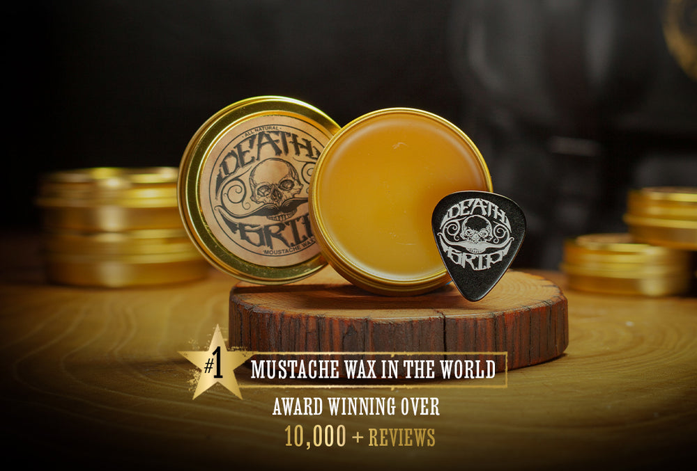 Death Grip mustache wax open tin with wax and branded pick on wooden stand with blurred tins in background
